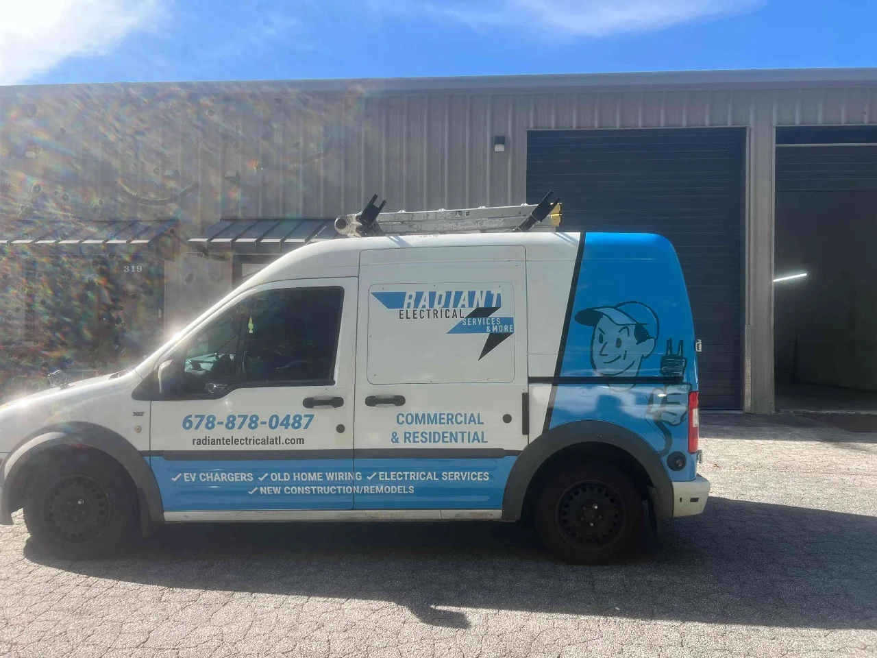 White and blue commercial service van with branded graphics