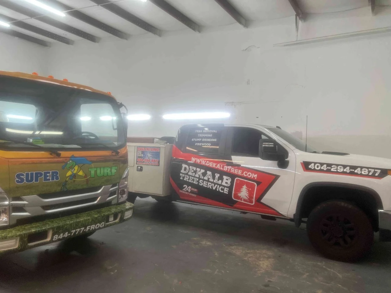 Two commercial pickup trucks with complementary branded graphics