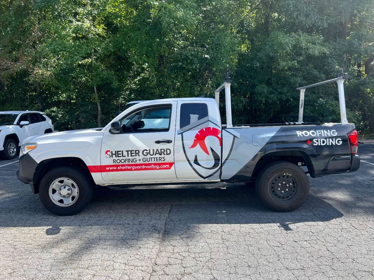 Helder Guard roofing and siding pickup with crisp commercial graphics