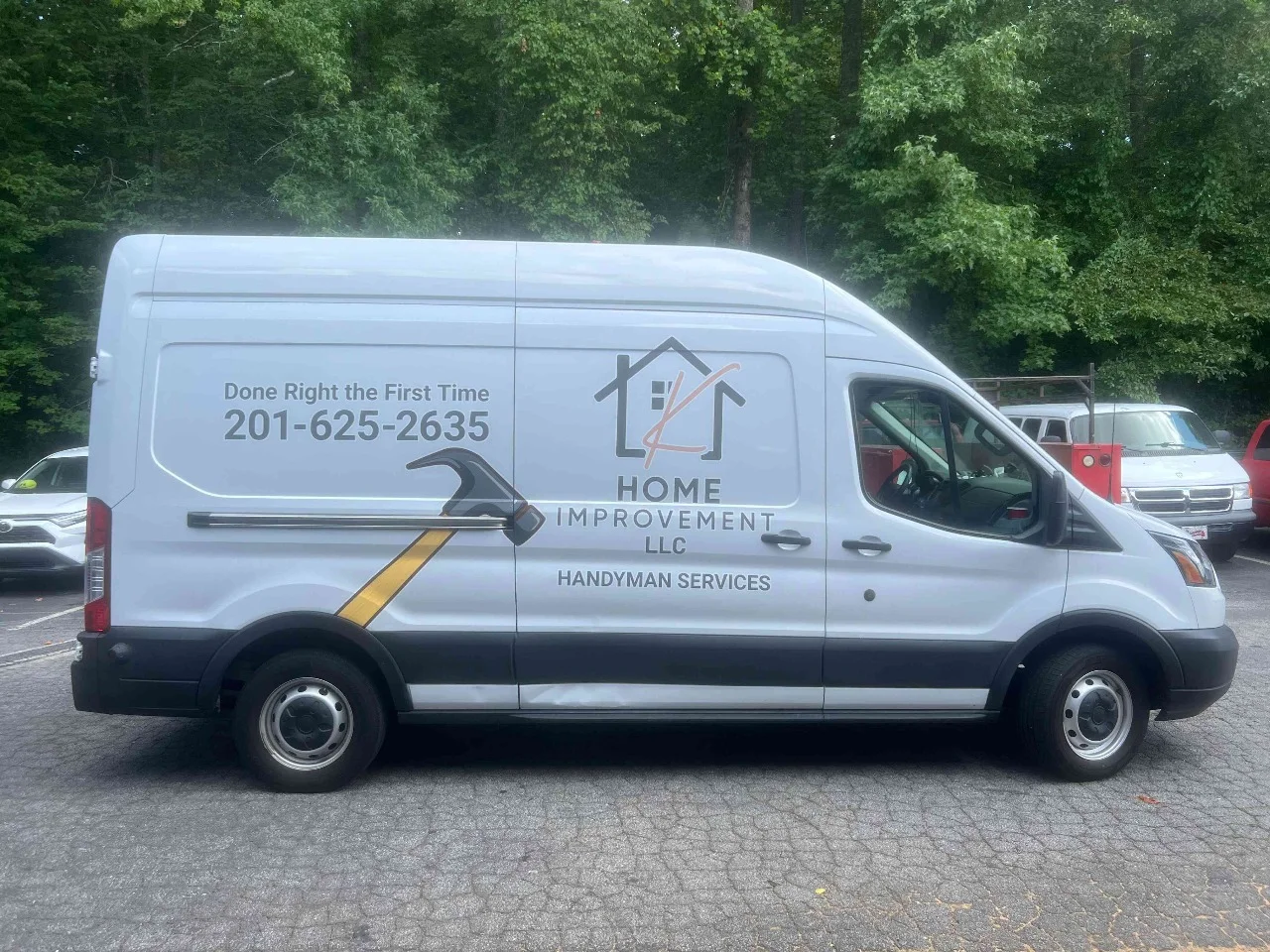 White home improvement van with clean gray and gold graphics